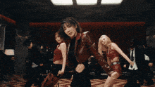 a woman in a red jacket with the letter b on her belt is dancing