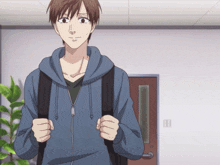 a man wearing a blue hoodie and carrying a black backpack