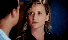 a man and a woman are looking at each other . the woman has a bruise on her forehead .