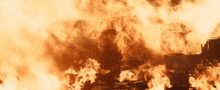 a building is on fire with a lot of flames and smoke