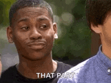 a man is making a funny face while talking to another man .