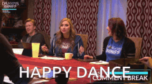 a group of people sitting around a table with the words happy dance on the bottom right