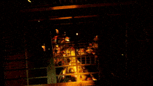 a dark room with a statue of a man behind a fence