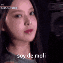 a close up of a woman 's face with soy de moli written in white