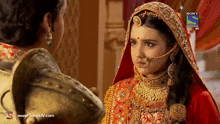 a bride and groom are looking at each other on a sony television ad