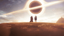 two people standing in a field looking at a large black hole in the sky