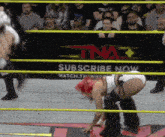 a wrestling ring with a sign that says subscribe now on it
