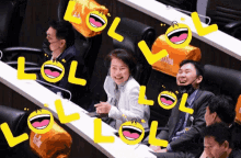 a group of people sitting in chairs with lol written in yellow