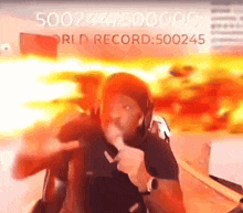 a man is giving a thumbs up in front of a sign that says world record 500245 .