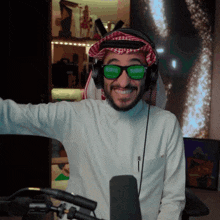 a man wearing green sunglasses and headphones is smiling