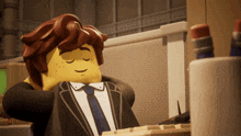 a lego man in a suit and tie is sitting in front of a computer with his eyes closed