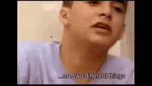 a young man is talking about two different things while wearing a blue shirt .