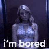 a woman sitting in an elevator with the words " i 'm bored " on the bottom