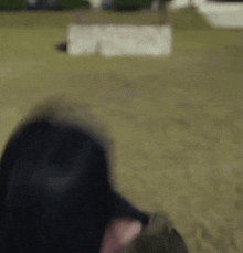a blurry picture of a person wearing a helmet in a field