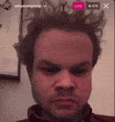 a man 's face is shown on a screen with a live icon