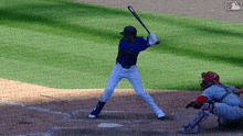 a baseball player getting ready to hit the ball with a mlb logo in the background