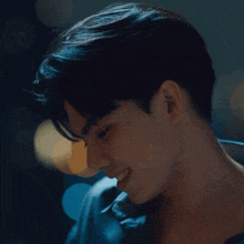a close up of a young man 's face with a smile on his face