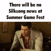a man in a suit is sitting at a table with the words " there will be no silksong news at summer game fest "