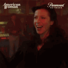 a woman in front of a sign that says american woman