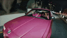 two women are driving a pink car with the dor brothers written on the side