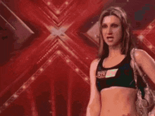 a woman in a crop top with the number 55 on her chest
