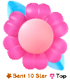 a pink flower with a blue leaf is sitting on a table .