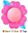 a pink flower with a blue leaf is sitting on a table .