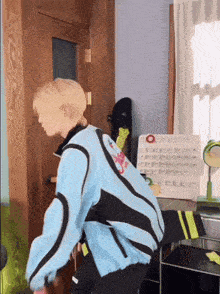 a person wearing a blue and black jacket is standing in a room