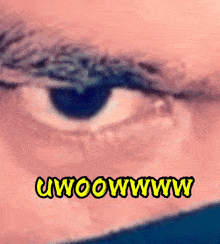 a close up of a person 's eye with the words uwoowww written in yellow
