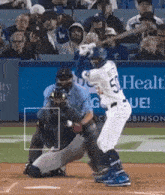 a baseball player with the number 5 on his jersey swings at a pitch