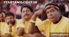 a group of men are sitting in a row wearing yellow shirts and hats .