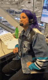 a woman with purple hair is wearing headphones and a jacket that says sharks