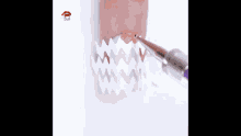 a close up of a person using a piping nozzle on a nail .