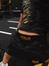 a woman wearing ufc shorts squatting down