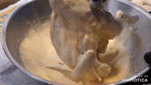 a person is pouring something into a metal bowl that says made in animatica