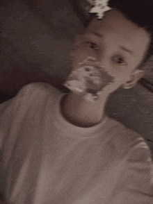 a young boy is taking a selfie with a teddy bear on his face