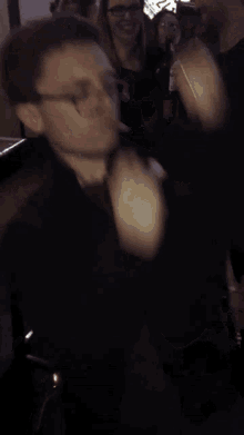 a blurry picture of a man dancing in a crowd of people