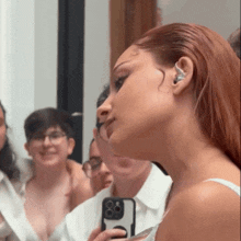 a woman taking a picture of herself in the mirror