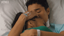 a man and woman kissing in a hospital bed with skymed written on the bottom right