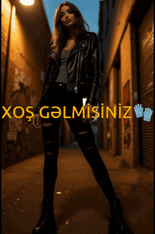 a woman wearing a leather jacket and ripped jeans is standing in a dark alleyway with the words xosgalmisiniz above her