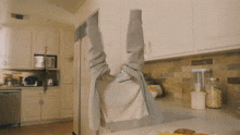 a person 's feet are sticking out of a refrigerator door