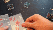 a person holding a piece of paper with a red star on it