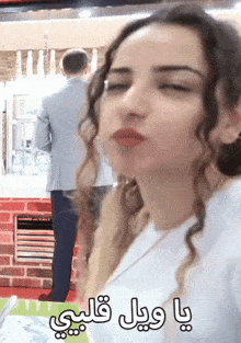 a woman making a funny face with arabic writing on it