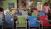a man sits in a row of lawn chairs with a yellow tag that says ' lawn chairs '