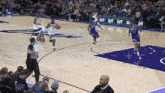 a basketball game is being played on a court with a banner that says lvt