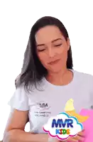 a woman wearing a white t-shirt with mvr kids on it
