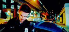 a pixelated image of a police officer standing next to a police car