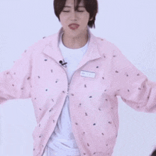 a person wearing a pink jacket with a name tag that says ' kwon '