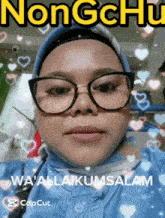 a woman wearing glasses and a hijab says nongchu wa ' alaikussalam