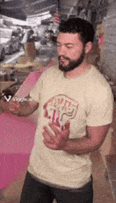 a man with a beard is wearing a t-shirt that says ' i love you ' on it